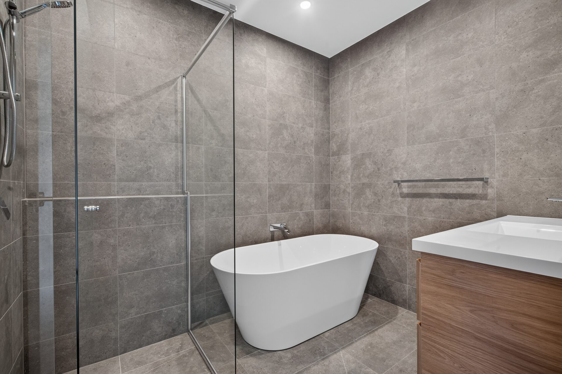 Bathroom with freestanding bath, walk-in shower and timber vanity