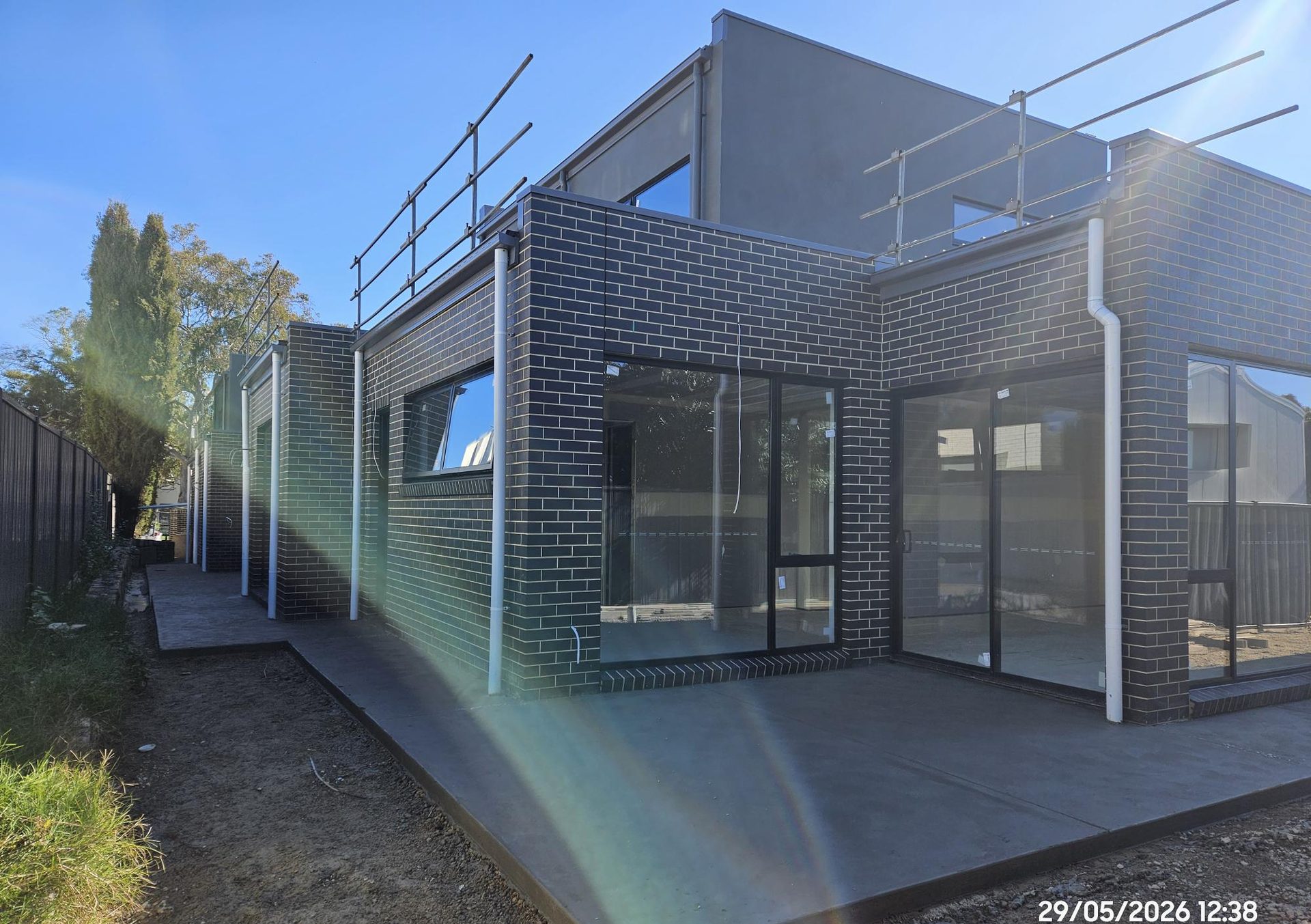 Covered outdoor terrace with full-height glazing opening from the living area